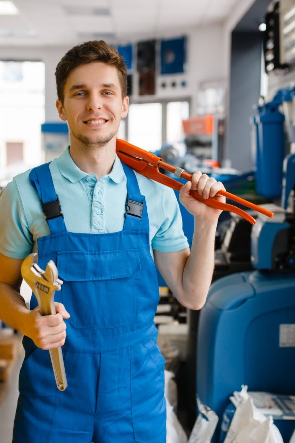 plumber-shows-pipe-wrenches-in-plumbering-store.jpg